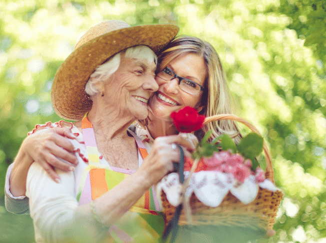 Senior woman and her adult daughter gardening on a nice summer day