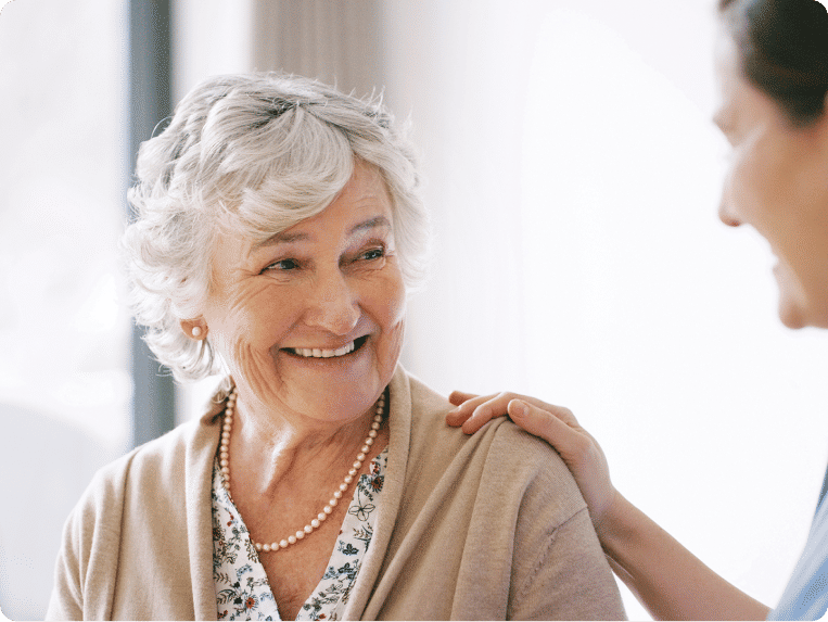 Older woman smiling at younger woman