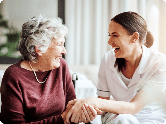 Senior woman and young adult woman enjoying time laughing together