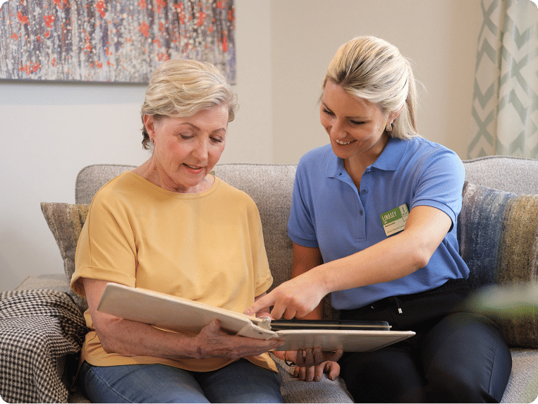 Two women looking at photo album