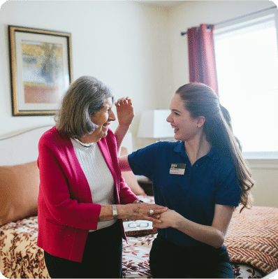 Senior woman and Atria employee smiling together