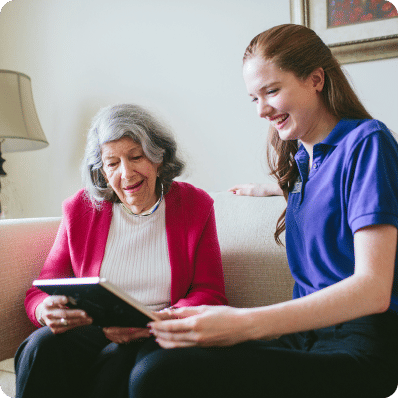 Two women looking at photo album