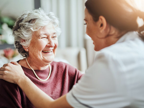 Shot of a young nurse caring for an elderly woman in a retirement home