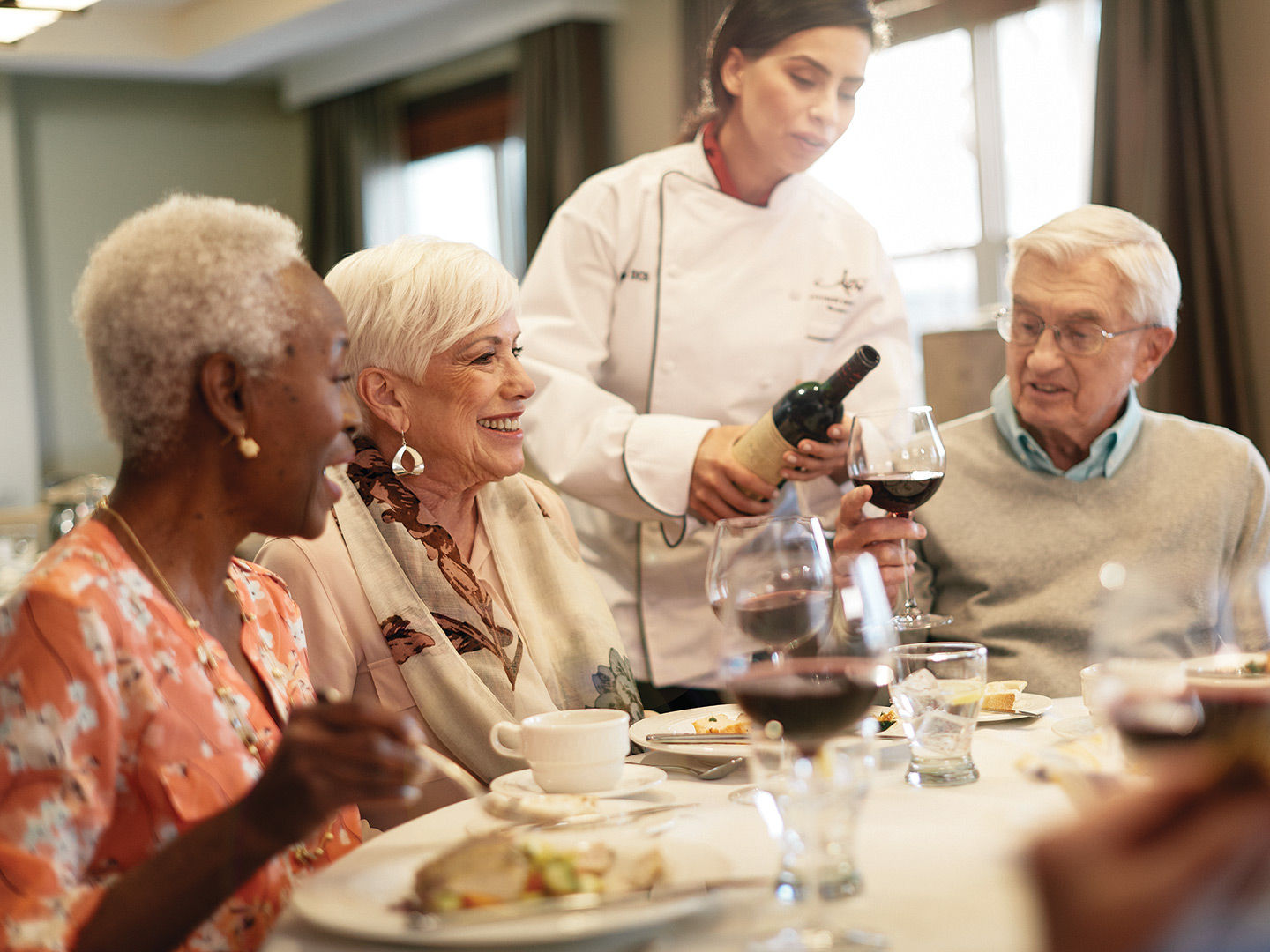 Photo of Atria residents enjoying dinner together