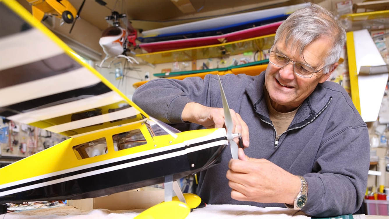 Senior man building a model airplane