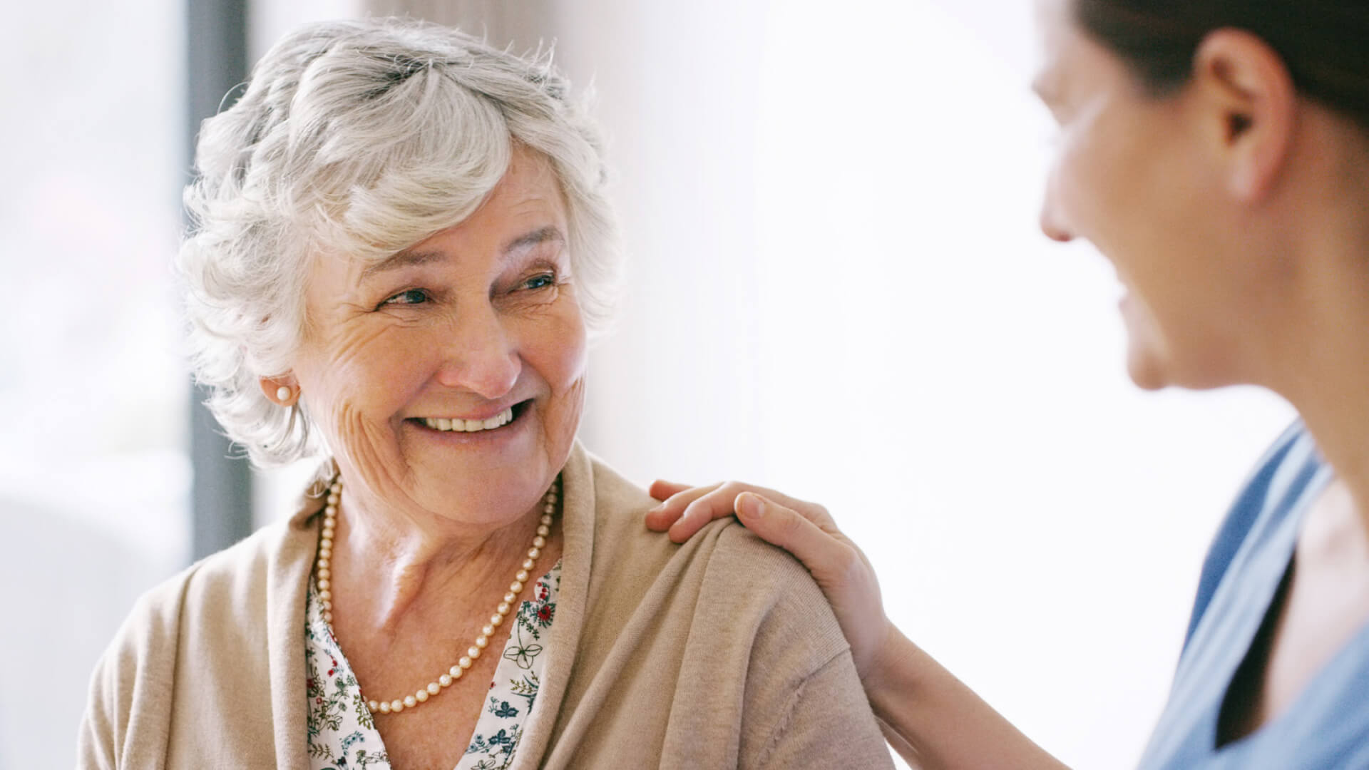 Older woman smiling at younger woman