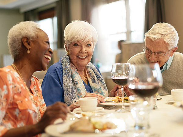 Photo of Atria Senior Living residents enjoying dinner together