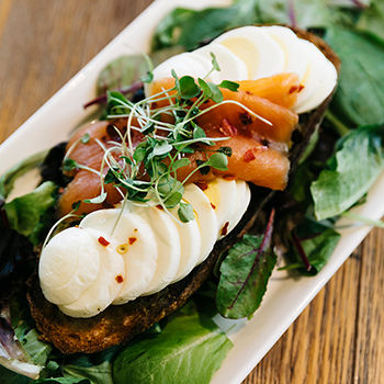 Photo of toast with greens, cheese, and salmon