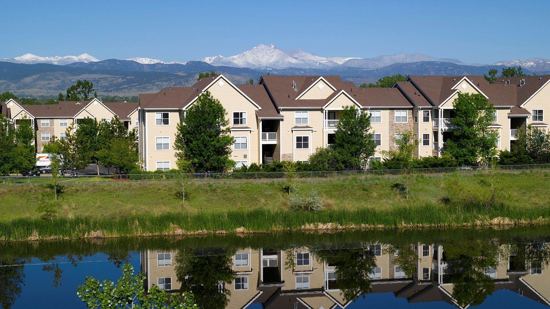 Atria Longmont exterior in front of the Rocky Mountains