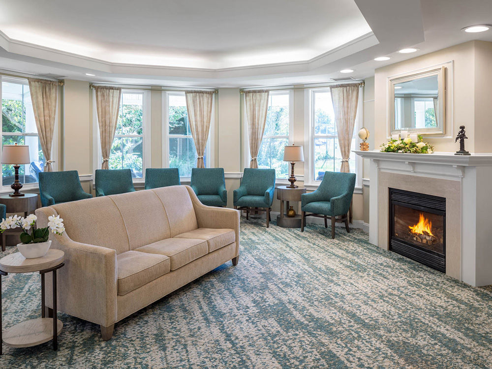 Living room with fireplace at Atria Plainview Senior Living