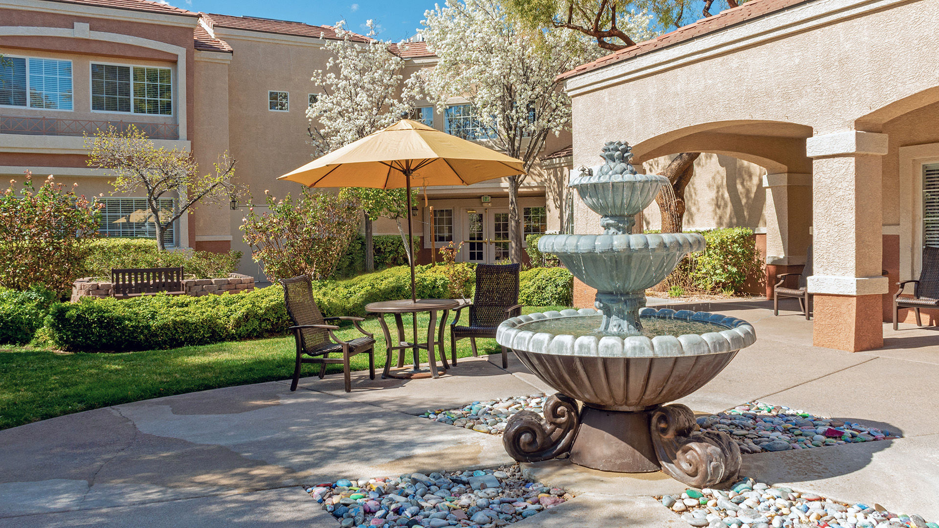 Atria Seville patio with fountain and shaded settee