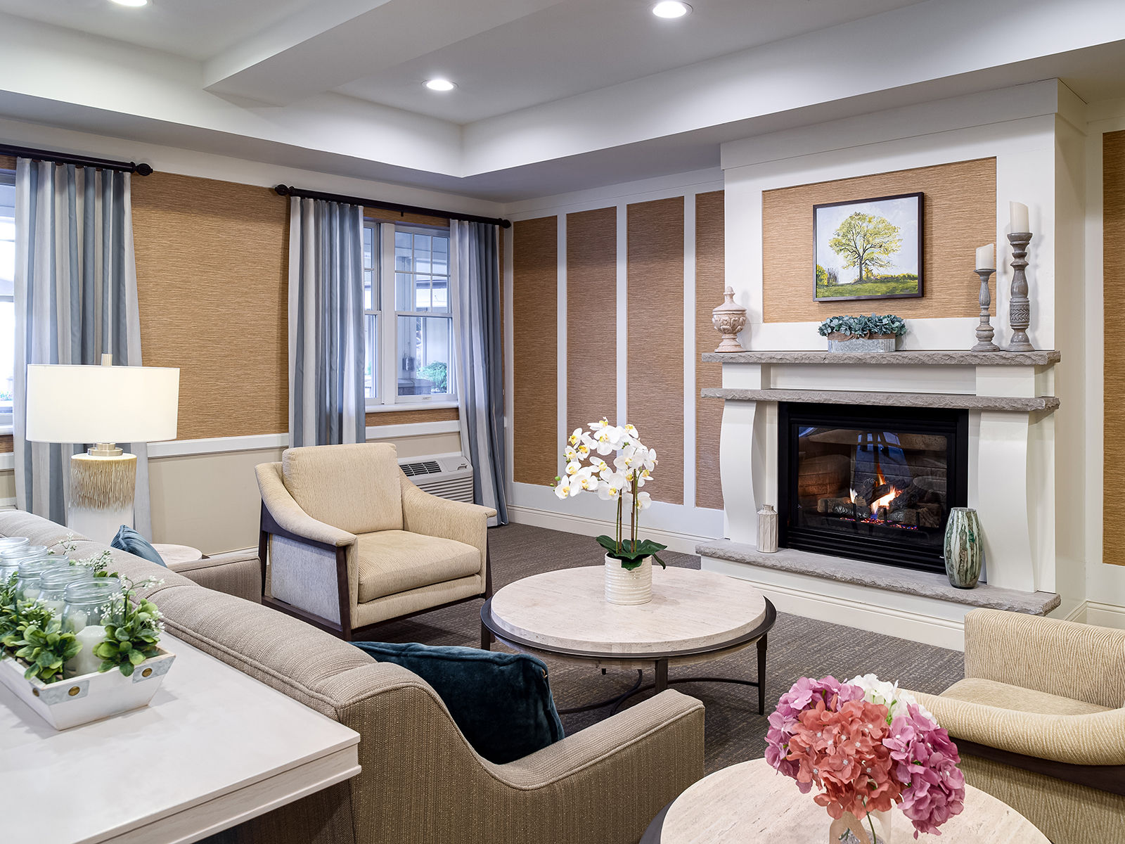 Atria Glen Cove modern community living room with cozy fireplace