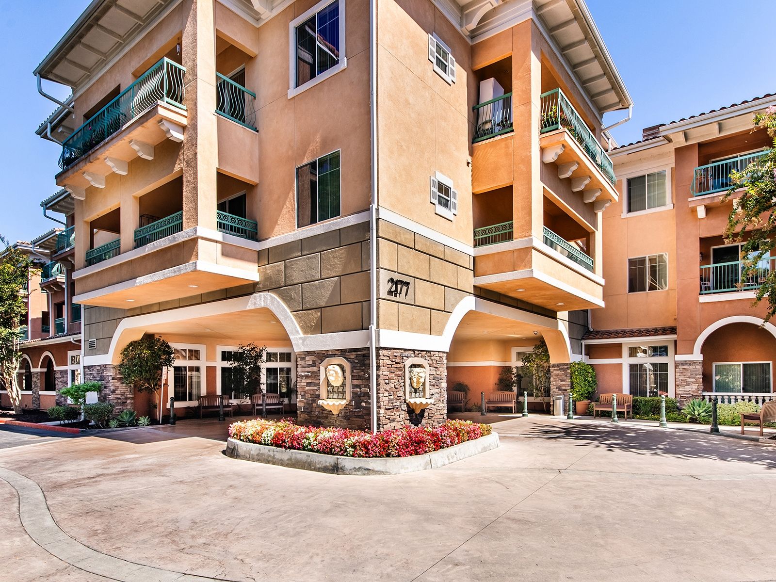 Exterior view of Atria Grand Oaks with porte cochere visible