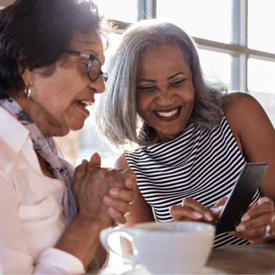 Senior woman and daughter enjoying coffee and conversation