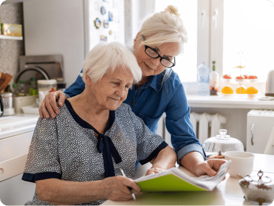 Senior woman and daughter looking over paperwork