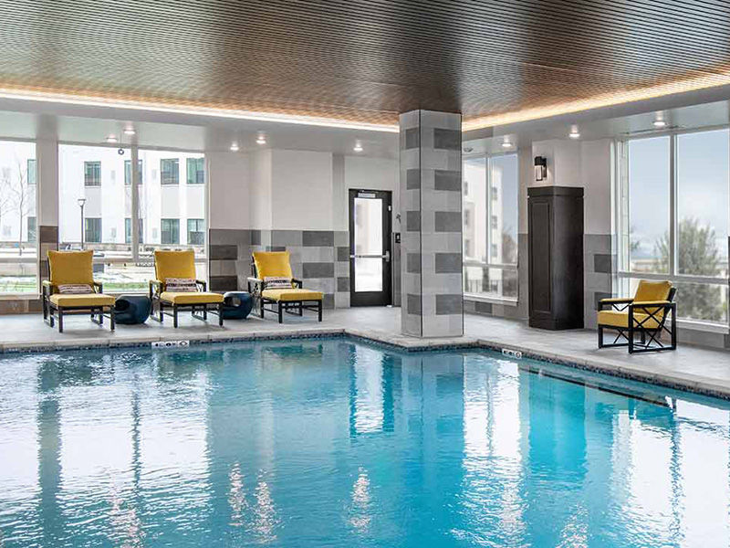 Indoor pool at Atria at cranberry Woods with seating around the pool.