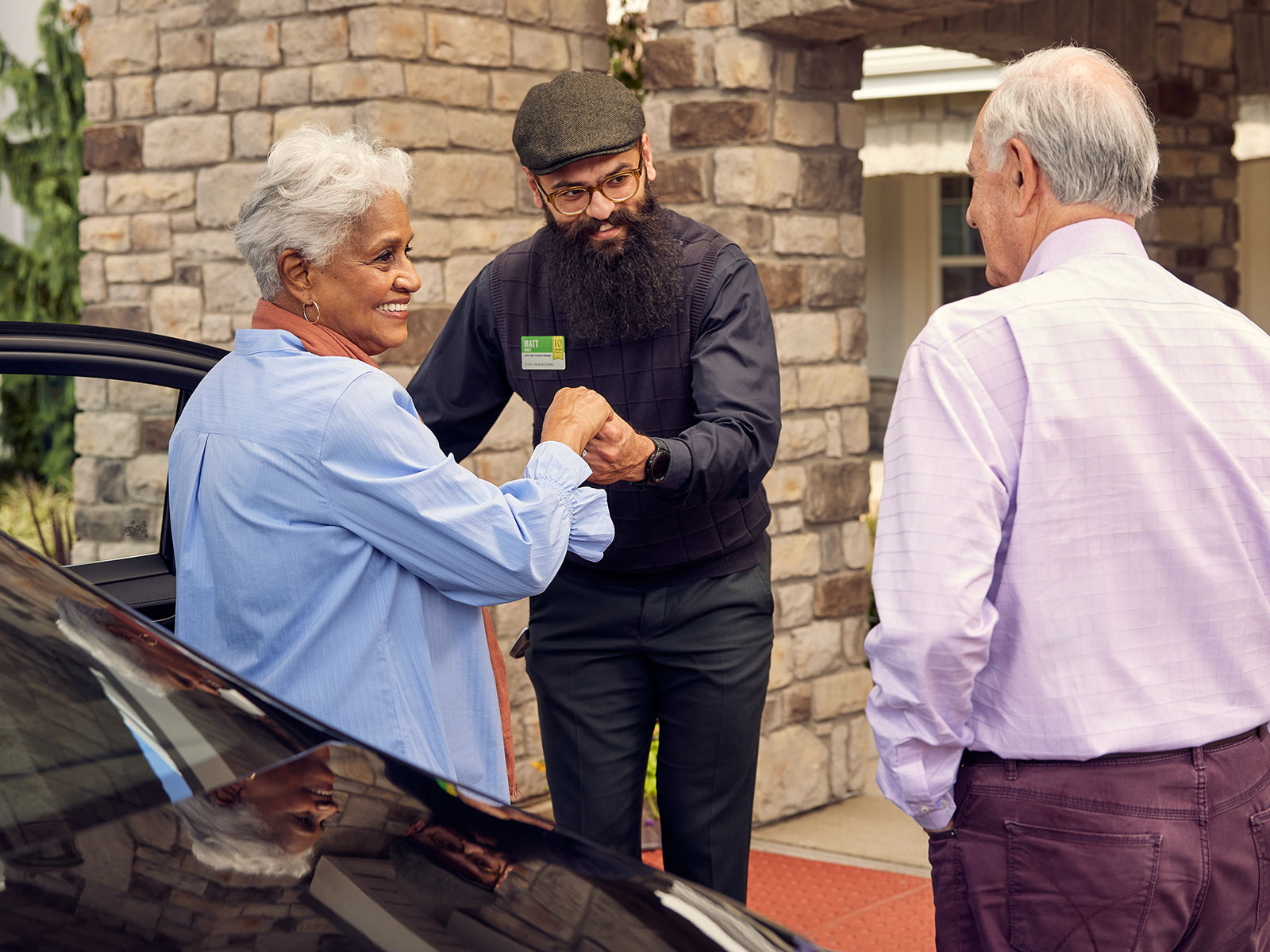 Senior woman exiting care with assistance from Atria staff member