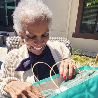 Senior woman opening a present