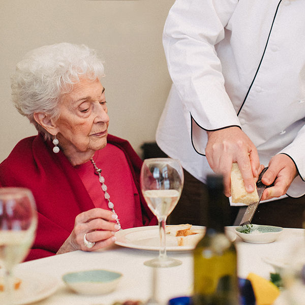 Senior woman being served dinner