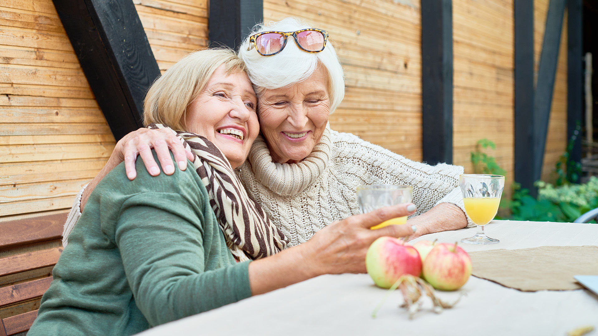 Senior women enjoying the crisp fall weather and fresh apples