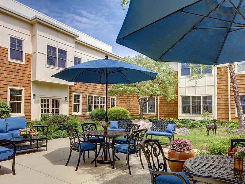 Modern patio with outdoor furniture with blue accents