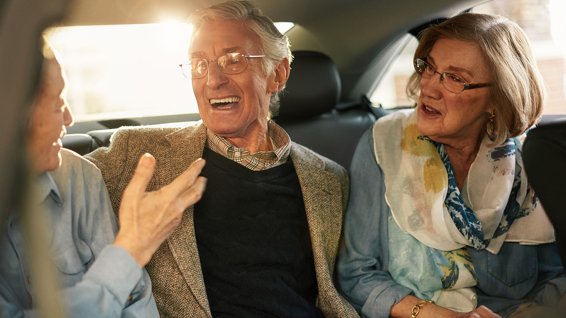 senior friends in the back of a taxi on their way to dinner reservations