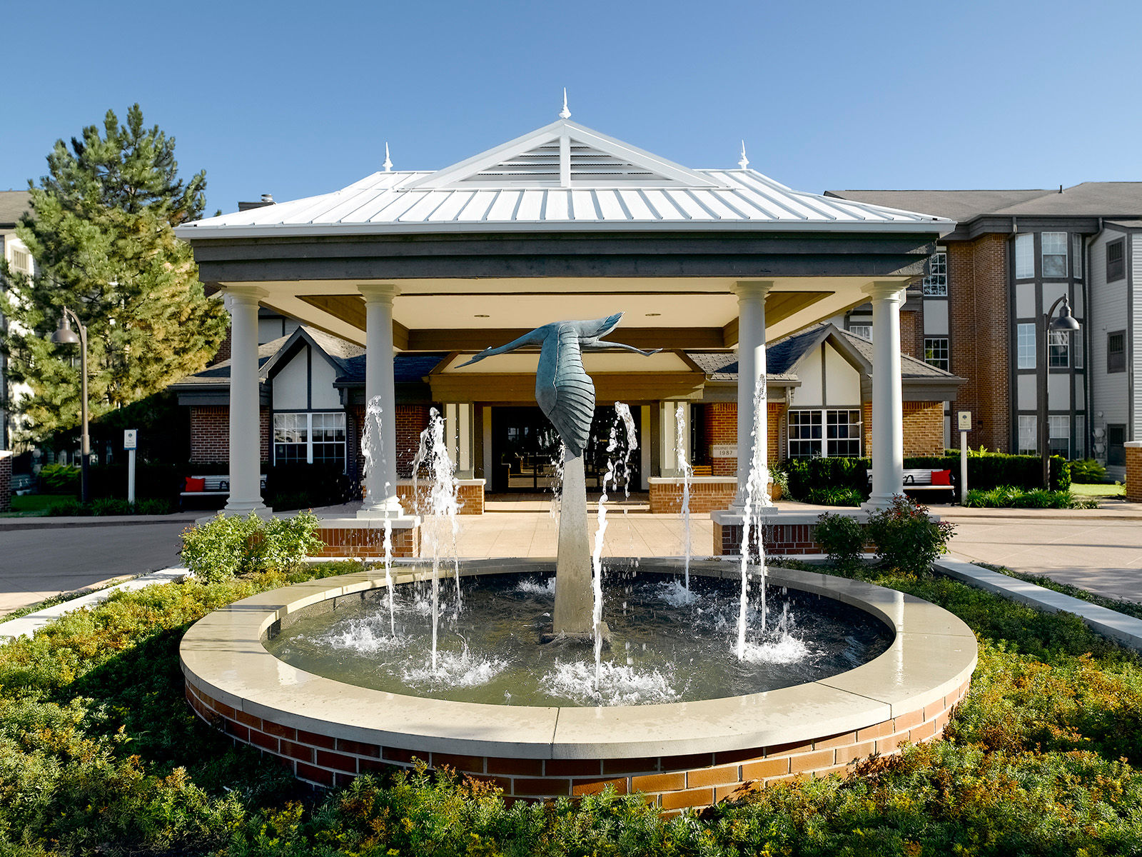 Atria Kinghaven exterior entrance featuring a large, beautiful water fountain