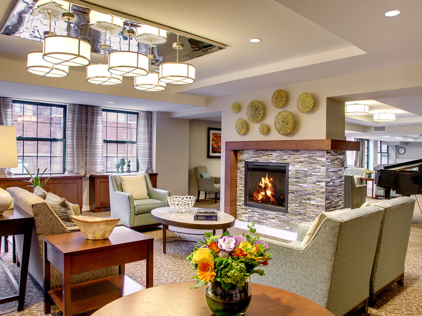 Atria Riverdale community living room with fireside seating