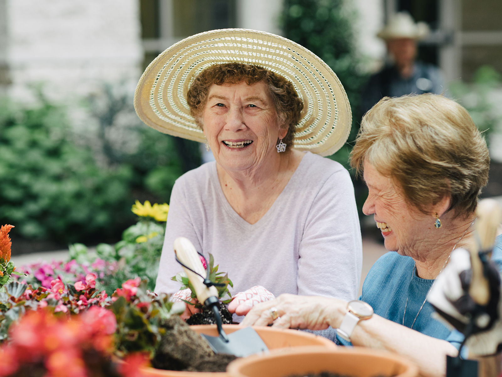two senior woman tending to the community garden