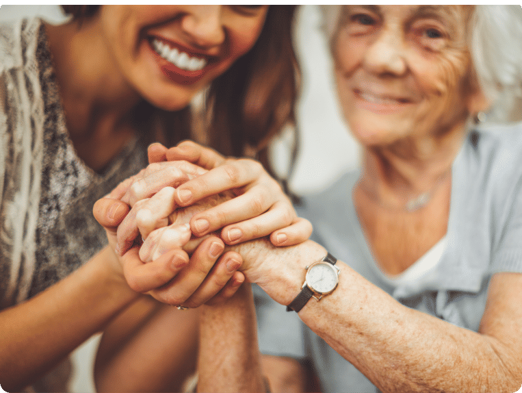 Senior holding young woman's hands and smiling