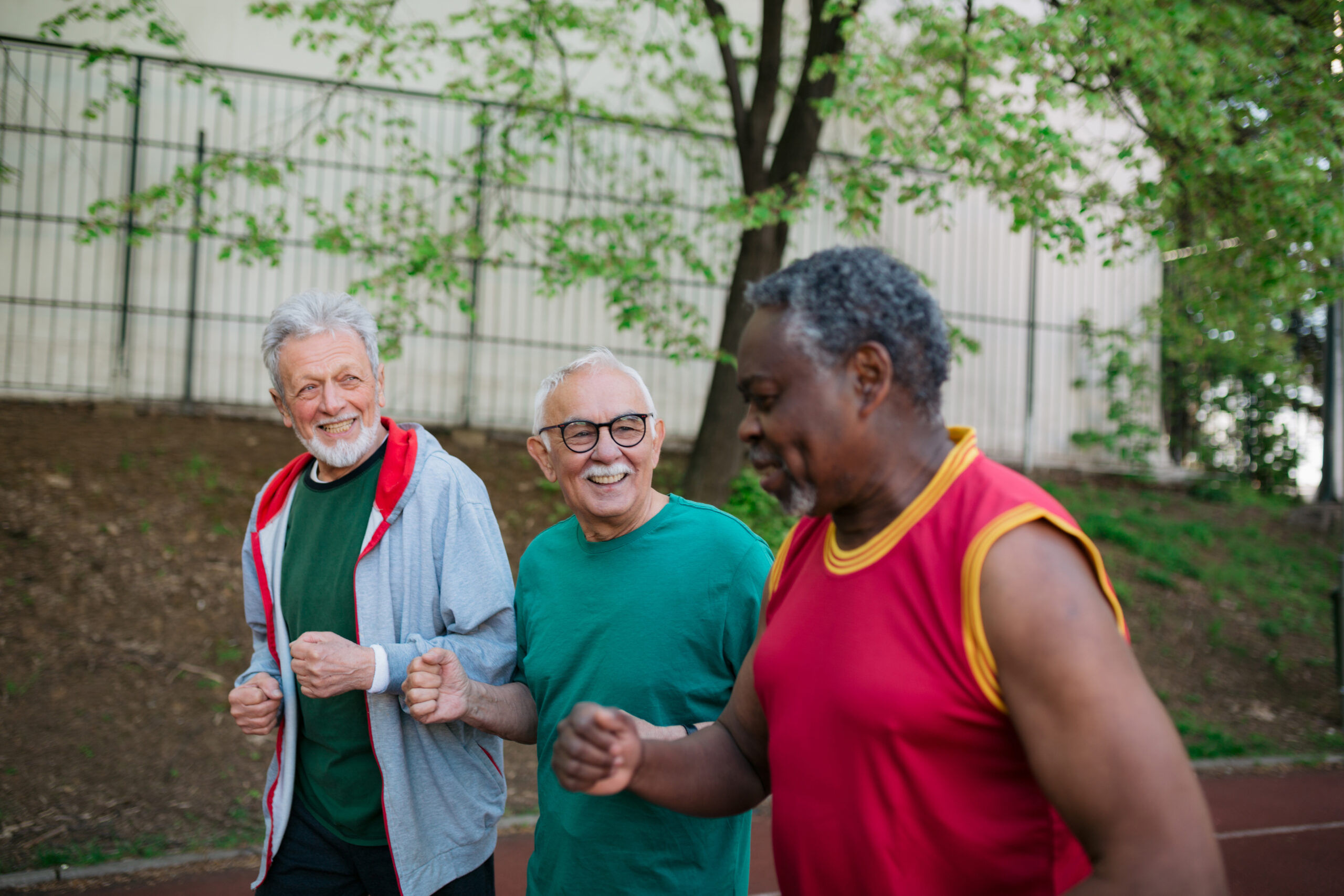 Three seniors power walking in park