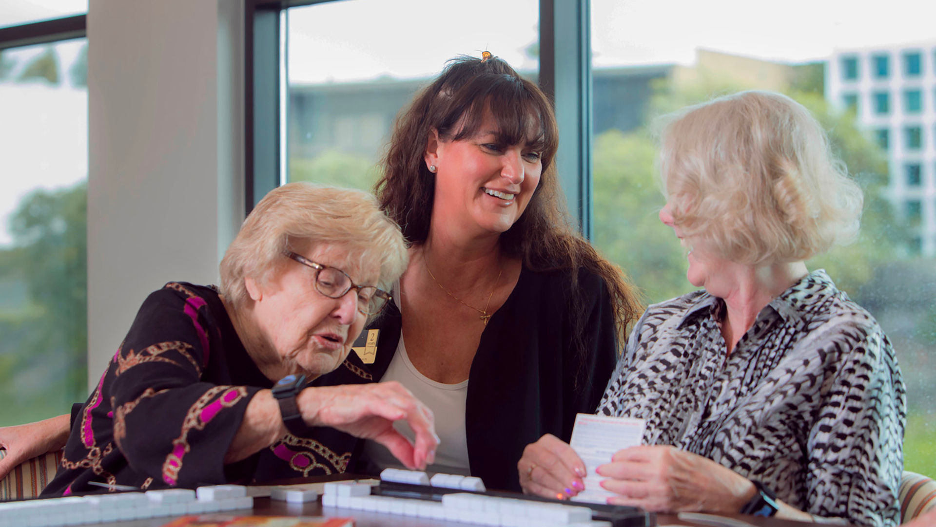 Two senior women and employee talking together