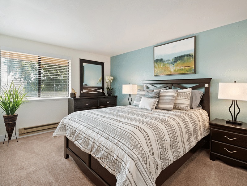 Bright and open senior apartment bedroom with queen sized