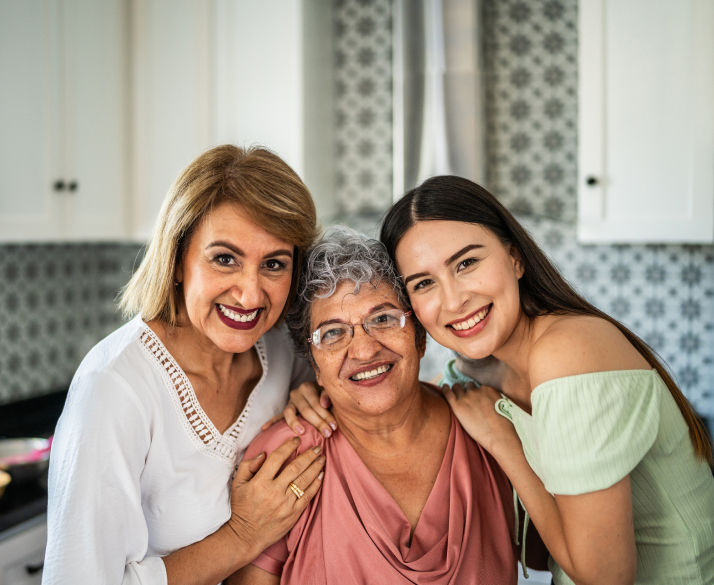 Three generations of women smiling for a photo