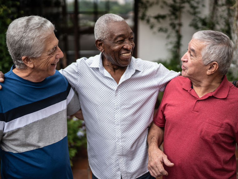 Group of male seniors hugging each other