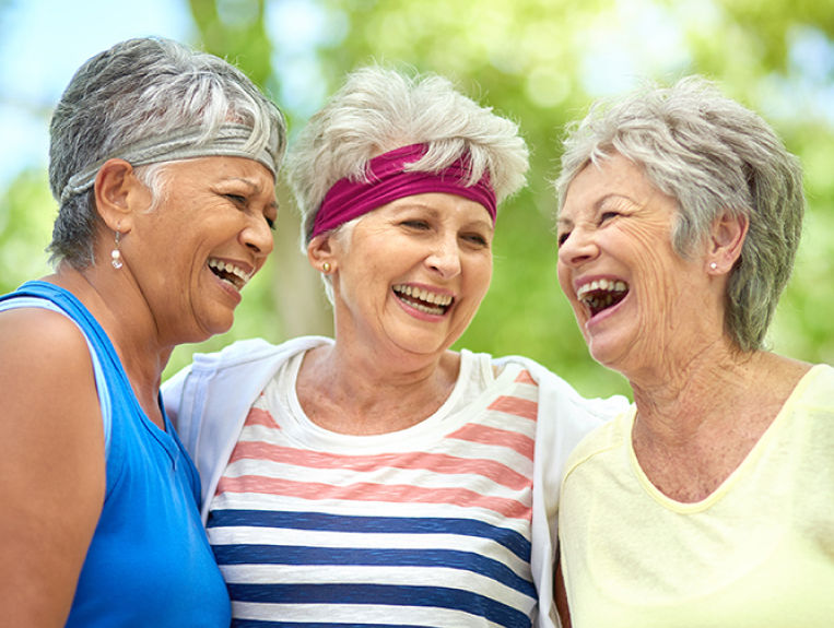 a group of woman in exercise gear laughing