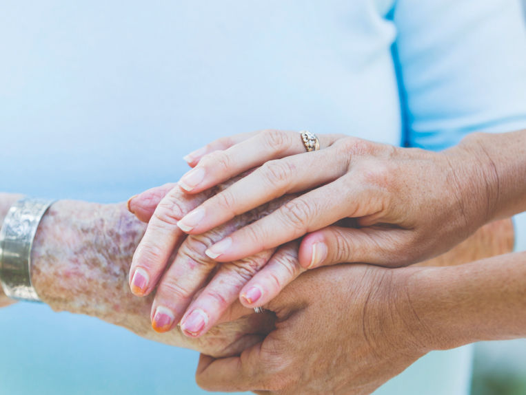 Two pairs of hands holding each other