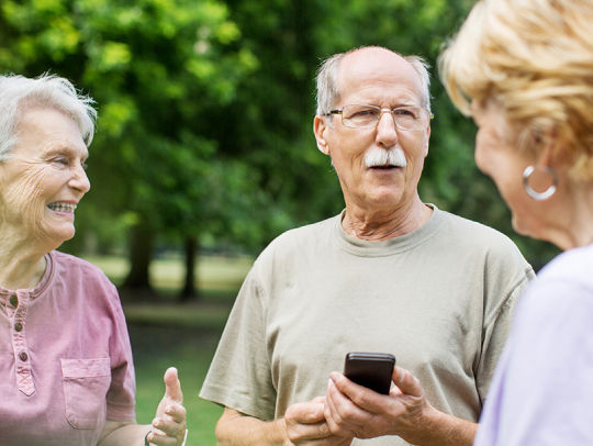 Senior man and women conversing with each other