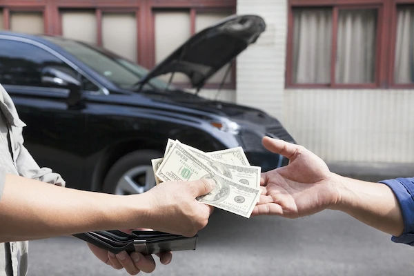 person giving money another person