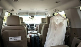Newlyweds arriving in a white SUV and driver with bilingual sign in Cancun, alongside views of a van interior and airport terminal with driver and bilingual sign