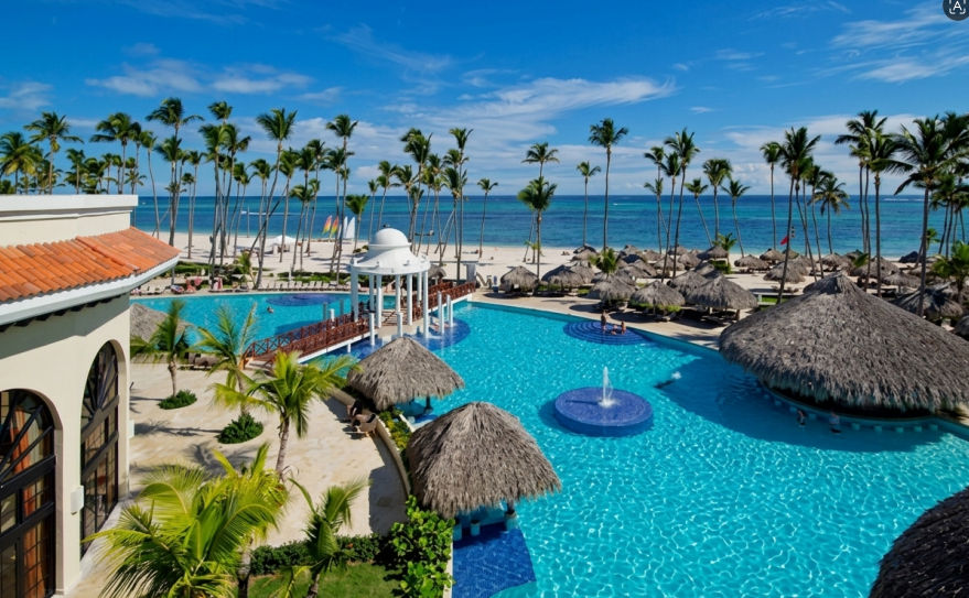Panoramic view of the main swimming pool and beach at Paradisus Palma Real Golf & Spa Resort in Punta Cana