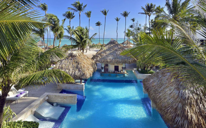 Tropical pool with swim-up bar and beachfront lounge areas at the Paradisus Punta Cana Resort