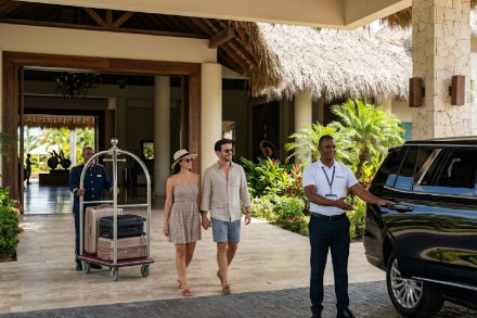 Driver waiting at hotel entrance for airport shuttle transfer