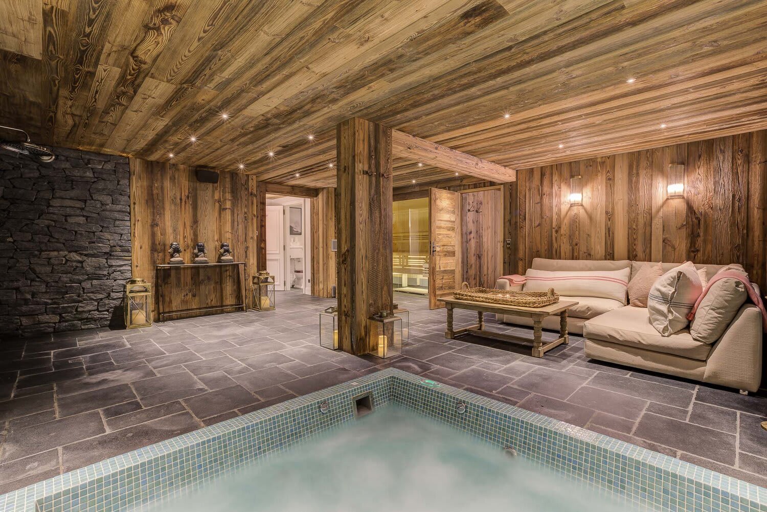 Spa area with indoor hot tub, lounge seating, and adjacent sauna