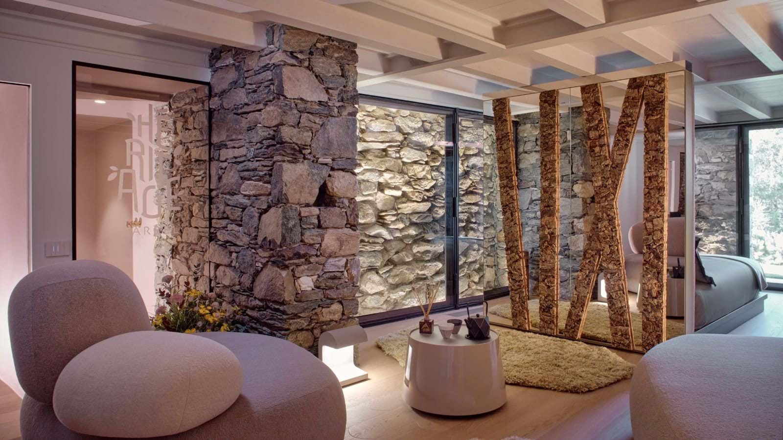 Lower level lounge with original stone walls and bedroom divider