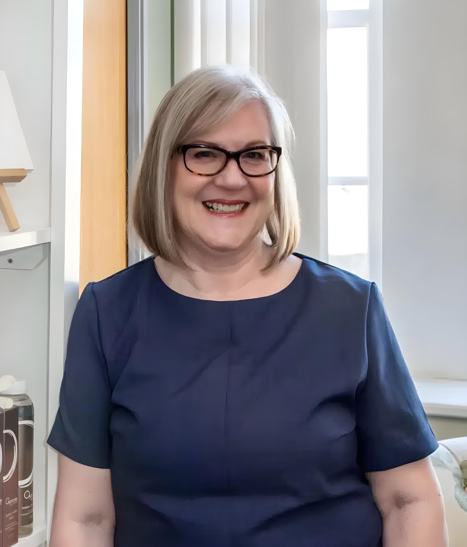 woman,smiling,indoors,glasses,blonde hair
