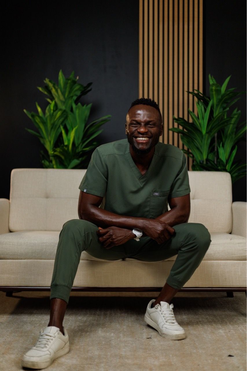  smiling,green scrubs,modern decor,relaxed pose 
