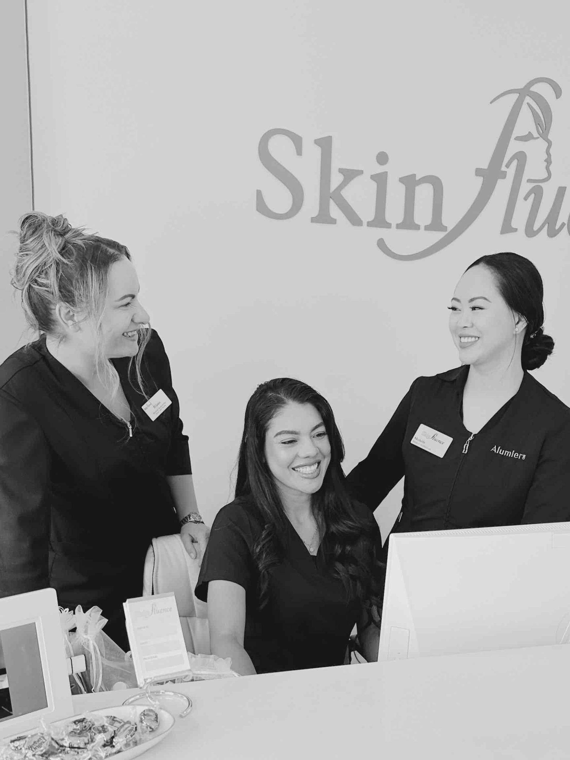 team,staff,smiling,desk,logo,black-and-white