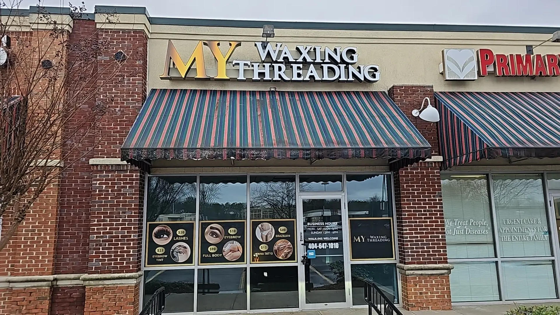 storefront,brick facade,signage,awning,beauty services