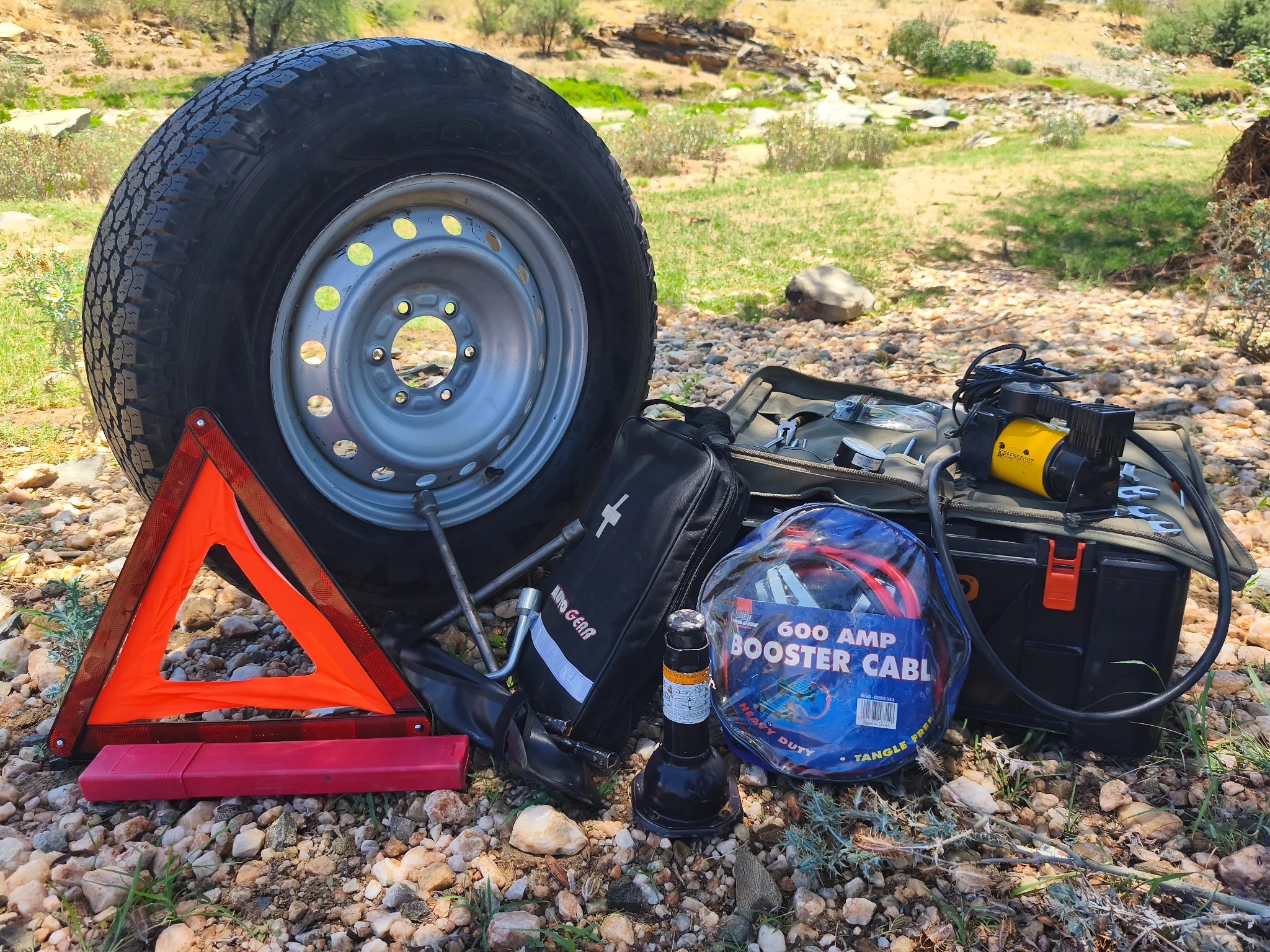 Toyota Hilux Camping emergency and roadside equipment including spare wheel, air compressor, jumper cables, first aid kit and warning triangle